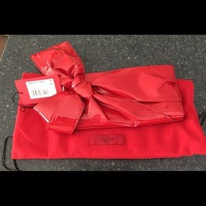 Valentino Garavani Patent leather bow clutch.